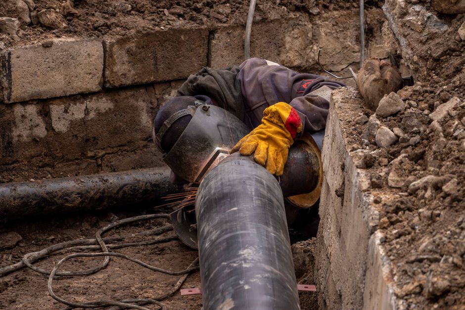 Drain technician inspecting a drain pipe in a residential street in Hayes, London